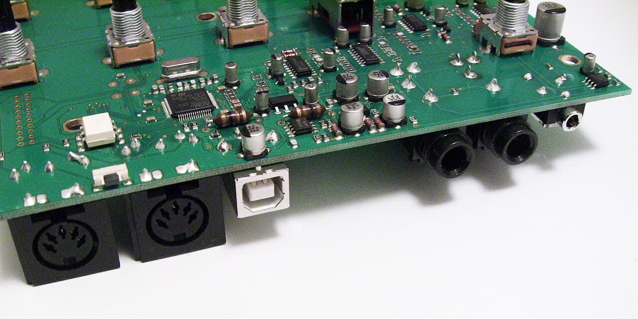 The connector board of a Waldorf Rocket synthesizer: a 5-pin DIN MIDI socket next to a USB port and audio jacks