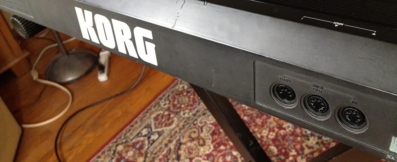 Rear panel of a Korg DW-8000 with its MIDI THRU, OUT and IN sockets